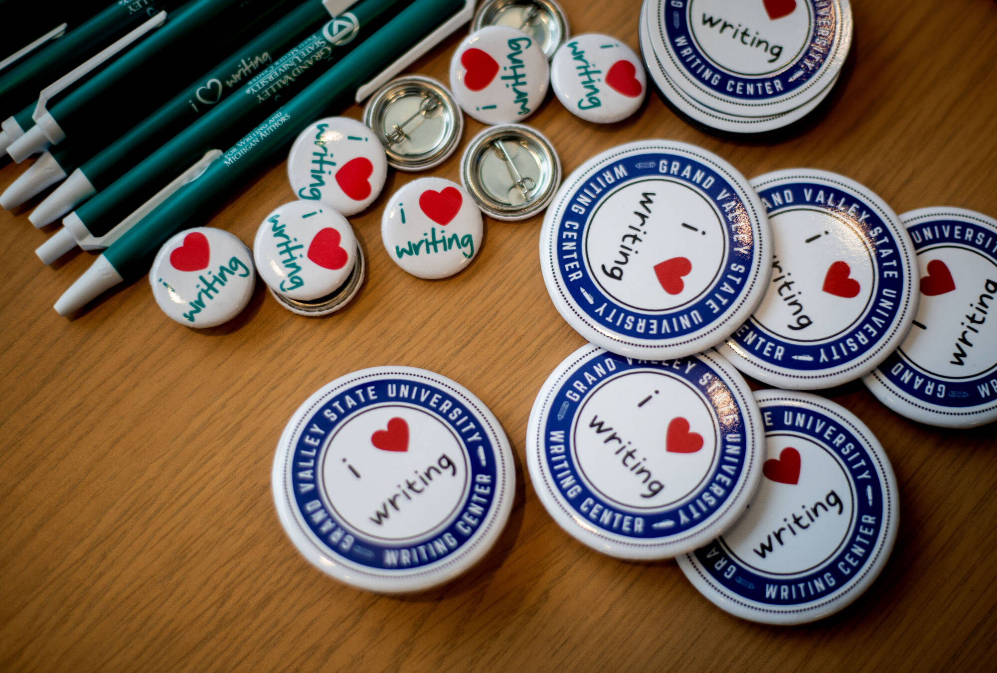 writing center buttons and pens on a table top